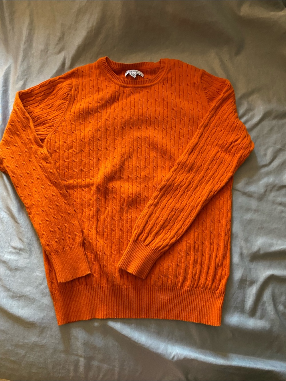 Kim Roger’s orange sweater